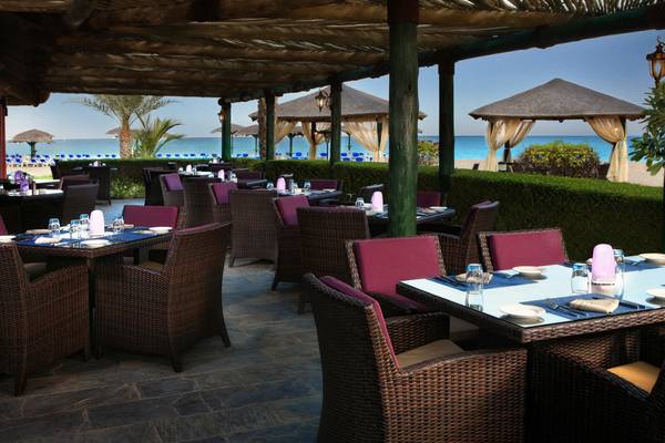 Außenterrasse des Fujairah Rotana Resort & Spa mit Blick auf das Meer.
