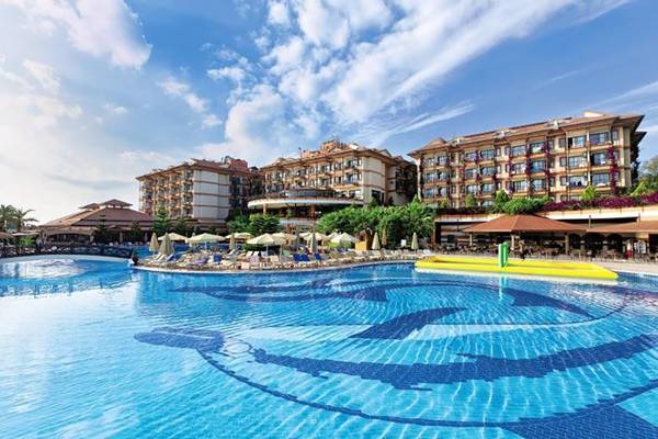 Außenbereich des Adalya ArtSide Hotels mit Swimmingpool und Sonnenliegen.