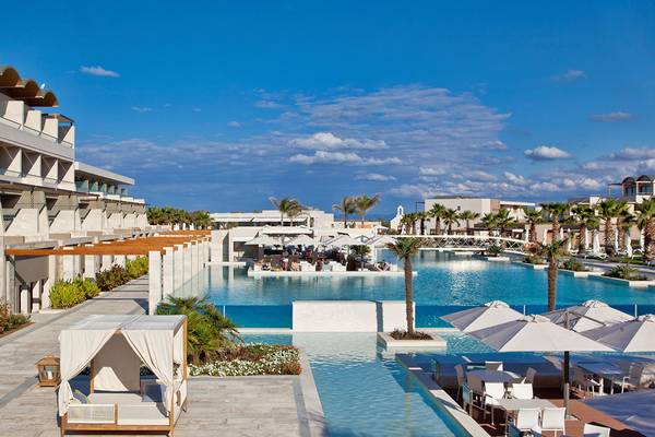 Außenbereich des Avra Imperial Hotels mit großem Pool und Sonnenschirmen