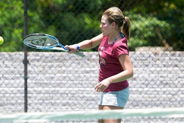 Junge Frau spielt Tennis auf einem Tennisplatz im Club Hotel Dolphin.