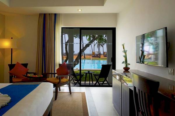 Innenansicht eines Zimmers im Club Hotel Dolphin mit Blick auf einen Swimmingpool.