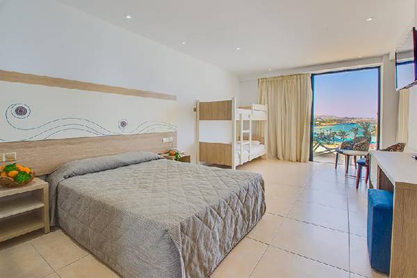 Doppelzimmer im Stamatia Hotel mit Meerblick, inklusive eines Bettes und eines Etagenbettes.