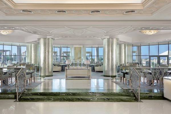 Innenbereich des Waldorf Astoria Ras Al Khaimah mit großen Fenstern und modernen Möbeln.