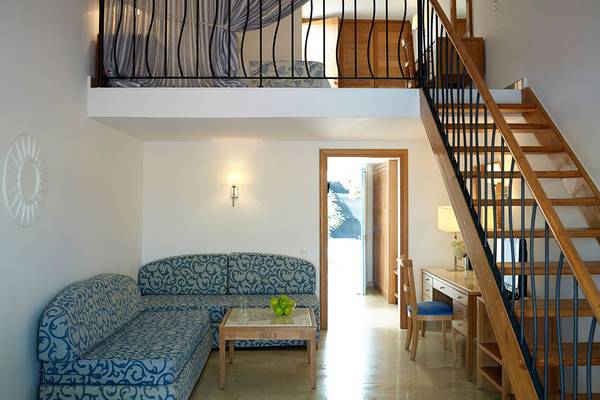 Innenraum des Mitsis Norida Beach Hotels mit Schlafbereich und Wohnbereich.