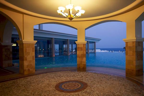 Außenpool des Atrium Prestige Thalasso Spa Resorts und Villas bei Nacht mit Blick auf das Meer.
