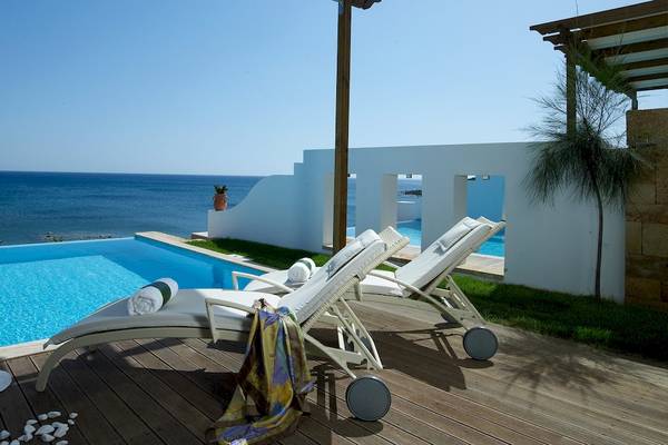 Außenpool des Atrium Prestige Thalasso Spa Resorts mit Sonnenliegen und Blick auf das Meer.