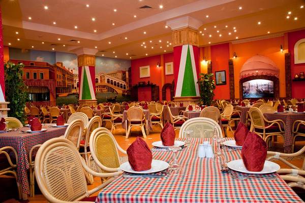 Innenansicht des Ali Baba Palace Restaurants mit vollen Tischen und Stühlen.
