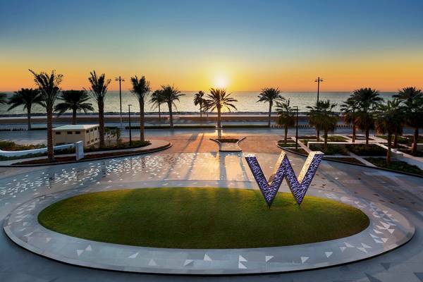 Sonnenuntergang am W Dubai - The Palm Hotel mit illuminiertem W Logo im Vordergrund