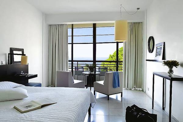 Zimmer im Almyra Hotel mit Blick auf das Meer und Balkon.