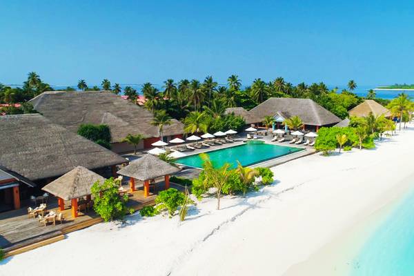 Außenansicht des Kudafushi Resort & Spa mit Swimmingpool und Bungalows am Strand