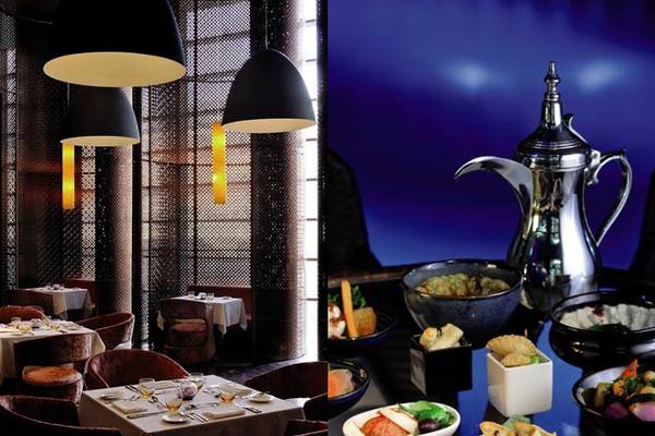 Restaurant des Southern Sun Abu Dhabi mit Tischen und Speisen im Vordergrund, eine Karaffe im Hintergrund.