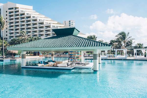 Gazebo im Poolbereich des Iberostar Selection Cancun Hotels mit Blick auf das Hauptgebäude.