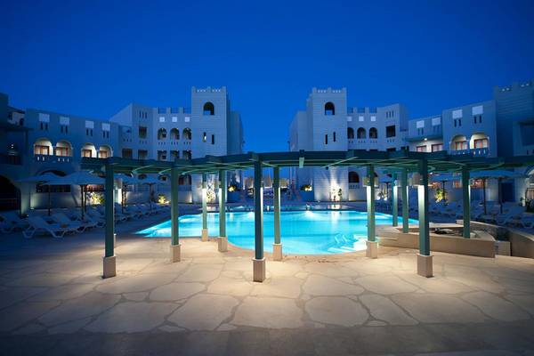 Fanadir Hotel El Gouna Pool bei Nacht mit Lounge-Sesseln und überdachter Pergola.