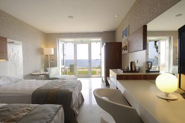 Zimmer im Gold Island Hotel mit Blick auf das Meer und Terrasse.