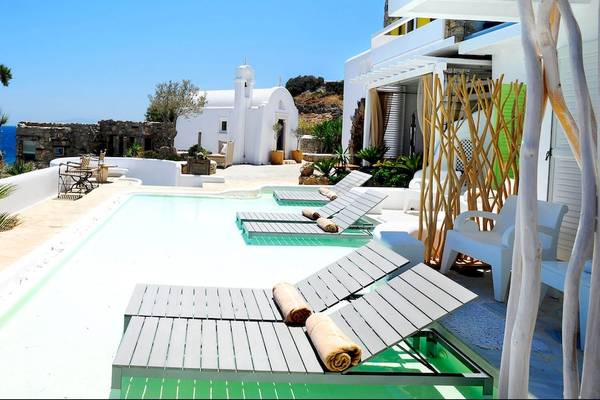 Pool- und Loungebereich des Kivotos Mykonos Hotels mit Blick auf das Meer.