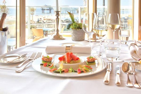 Elegantes Esstisch-Setup im Crystal Tat Beach Golf Resort & Spa mit Blick auf das Meer.