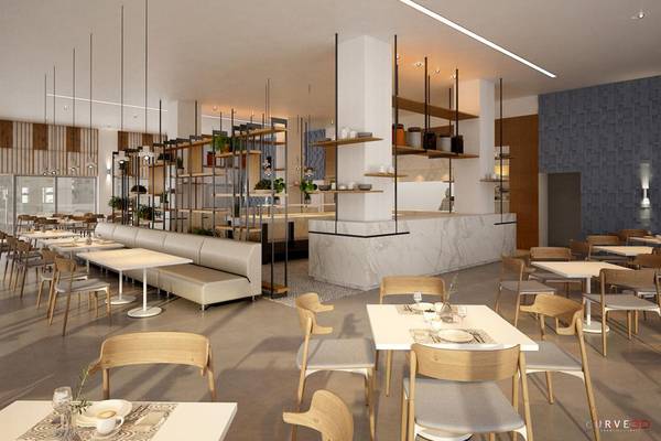 Innenansicht des NissiBlu Beach Resort Restaurants mit modernem Design, weißen Tischen, grauen Stühlen und einer Theke.