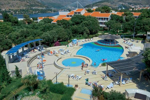 Luftaufnahme des Valamar Tirena Hotels mit Swimmingpools, Liegestühlen und Besuchern.