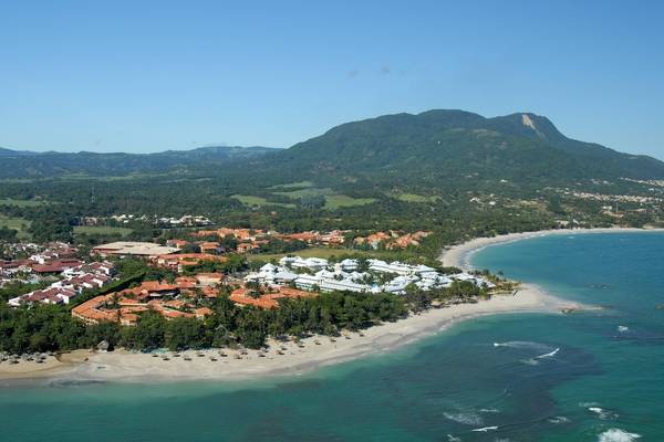 Luftaufnahme des Gran Ventana Beach Resorts an einer weißen Sandbucht mit blauem Wasser und grünen Bergen im Hintergrund.