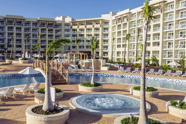 Außenbereich des Melia Marina Varadero Hotels mit Swimmingpool, Liegestühlen und Palmen