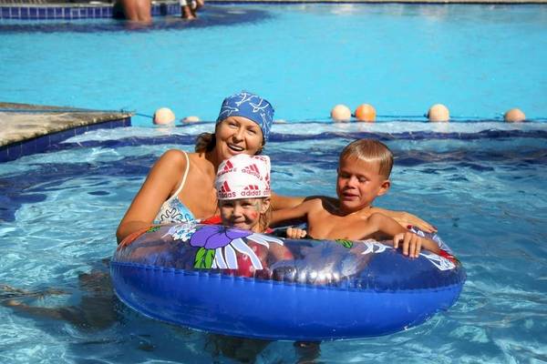 Frau und zwei Kinder schwimmen im Hotelpool Sea Star Beau Rivage