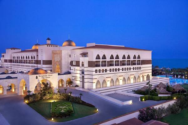 Außenansicht des Kempinski Hotels The Dome in Belek bei Nacht mit Beleuchtung und Pool