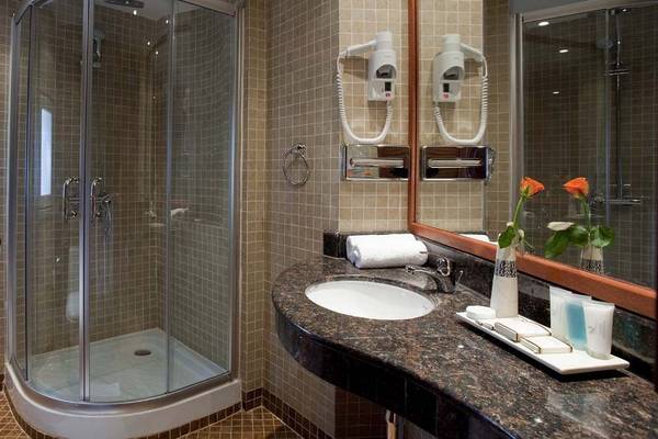 Badezimmer im Bahari Beach Hotel mit Dusche und Waschbecken
