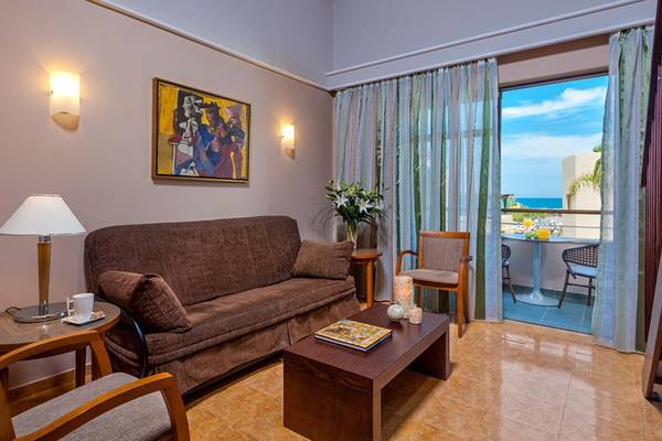 Wohnzimmer im Hotel Porto Platanias Beach Resort & Spa mit Blick auf den Ozean.