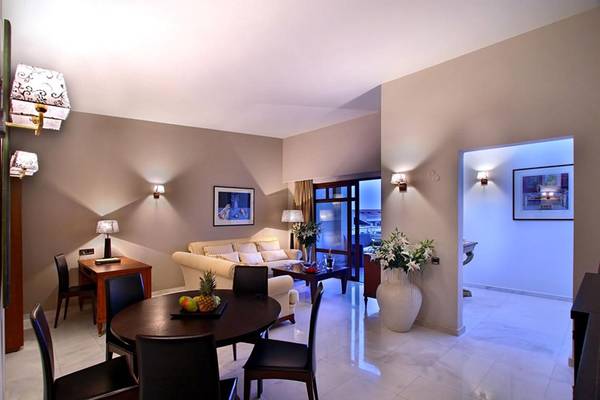Innenbereich des Porto Platanias Beach Resort & Spa mit Esstisch, Früchten und Deko.