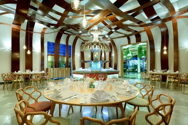 Innenbereich des Grand Palladium Kantenah Resort & Spa mit modernen Möbeln und einer geometrischen Deckengestaltung.