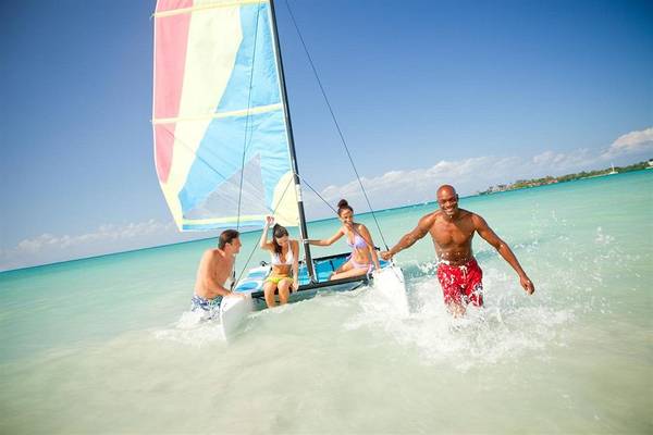Familie im Couples Negril Hotel beim Segelbootfahren am Strand