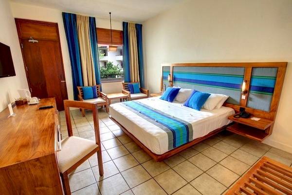 Doppelzimmer im Mermaid Hotel & Club mit Bett, Schreibtisch, Stühlen und Fenstern.