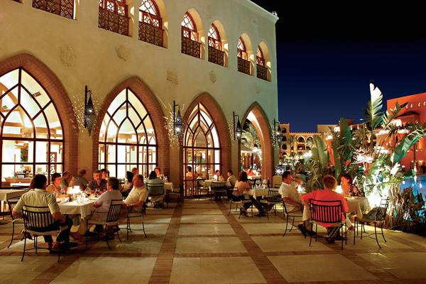 Gäste sitzen in einem Außenrestaurant des Makadi Palace bei Nacht.