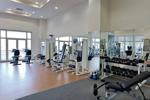 Fitnessstudio im Selectum Colours Bodrum Hotel mit vielen Geräten und großen Fenstern.