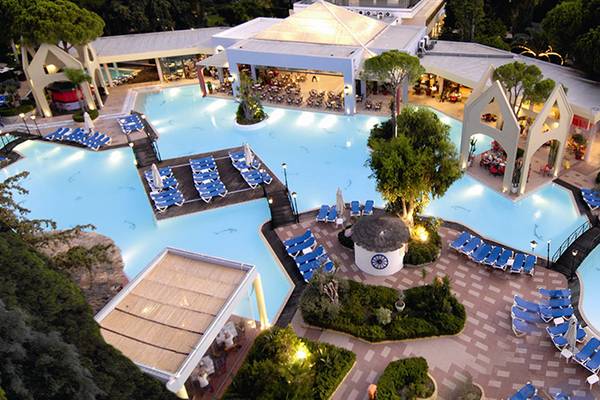 Luftaufnahme des Dionysos Hotels mit Swimmingpool und vielen Liegestühlen.