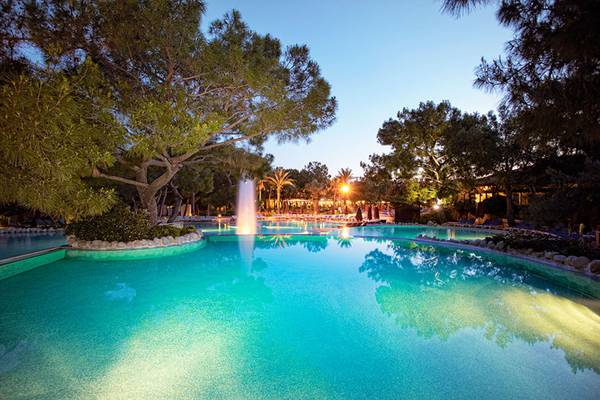 Außenpool des Hotels Marti Myra bei Nacht mit einer Wasserfontäne.