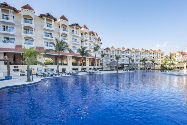 Außenbereich des Occidental Caribe Hotels mit großem Swimmingpool und Liegestühlen.