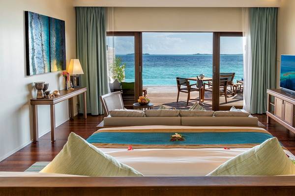 Hurawalhi Island Resort Zimmer mit Meerblick, große Terrasse, Möbel und Fernseher.