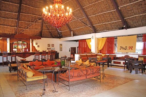 Loungebereich im Karafuu Beach Resort & Spa mit rotem Kronleuchter und bunten Möbeln.