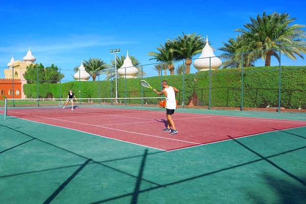 Tennisplatz im Pickalbatros Alf Leila Wa Leila Resort mit zwei Spielern und einer umzäunten Anlage.
