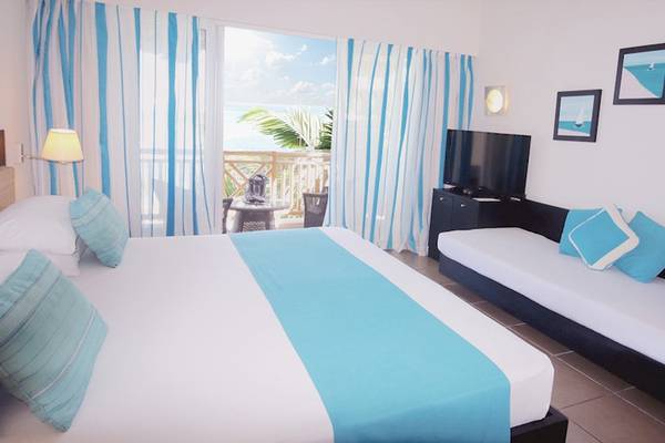 Ein modernes Hotelzimmer im Pearle Beach Resort & Spa mit Blick auf das Meer.