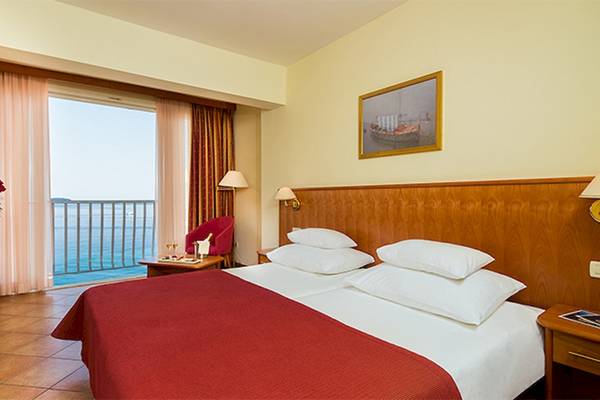 Zora Hotel Zimmer mit Meerblick, Bett, Fernseher und Balkon