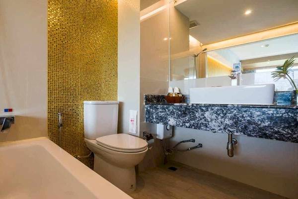 Badezimmer im Chaba Samui Resort mit Badewanne, Toilette und Waschbecken.