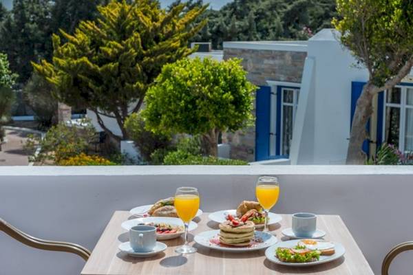 Frühstück auf dem Balkon im Naxos Palace Hotel mit Orangensaft, Gebäck und mehr.