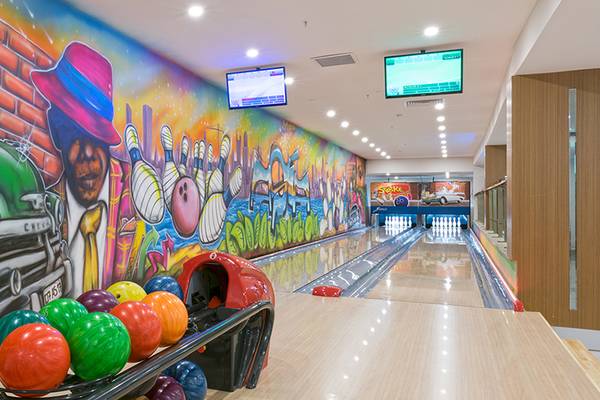 Bowlingbahn im Asia Beach Resort & Spa mit bunten Wandmalereien und Bowlingkugeln.