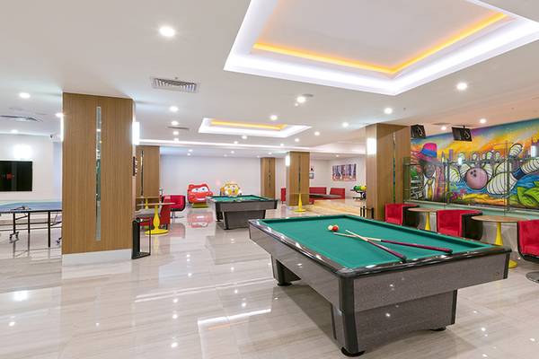 Spielzimmer im Asia Beach Resort & Spa mit Billardtisch, Tischtennisplatte und bunter Graffitiwand.