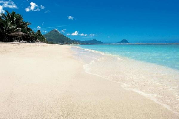 Strandszene am Sugar Beach Hotel auf Mauritius mit weißem Sand und blauem Wasser