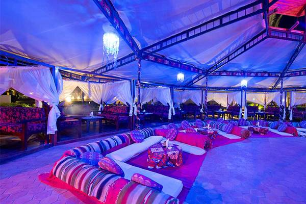 Loungebereich im Amphoras Beach Hotel mit blauer Beleuchtung, weichen Sitzgelegenheiten und Tischchen.