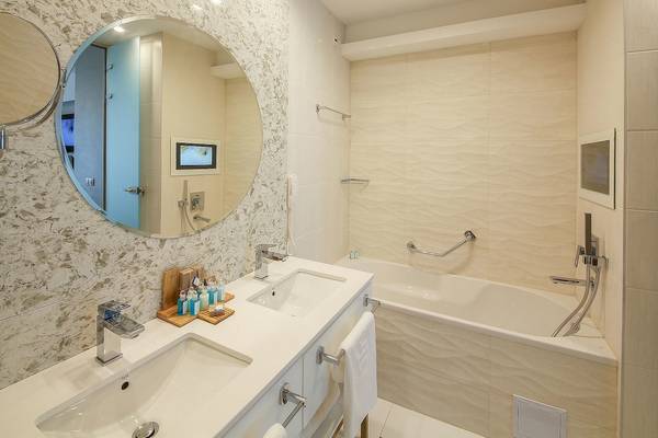 Badezimmer im Maritim Hotel Paradise Blue Albena mit Doppelwaschbecken, Badewanne und Spiegeln.