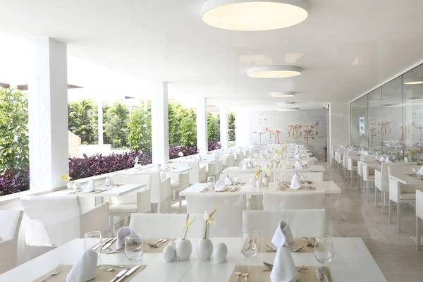 Weißes Speisesaal im Iberostar Selection Playa de Palma Hotel mit modernen Möbeln und Spiegelwänden.
